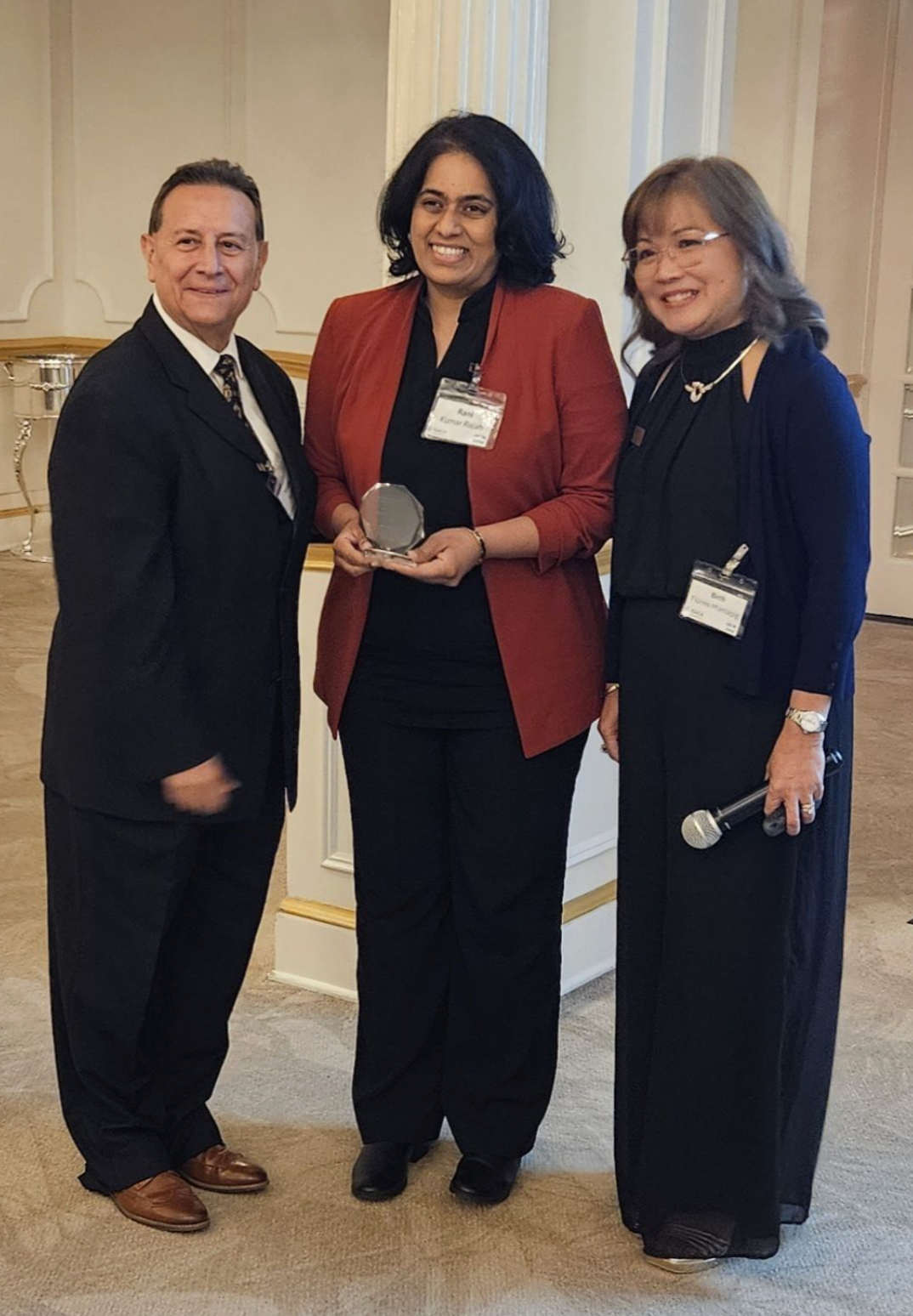 Rani receiving a recognition award